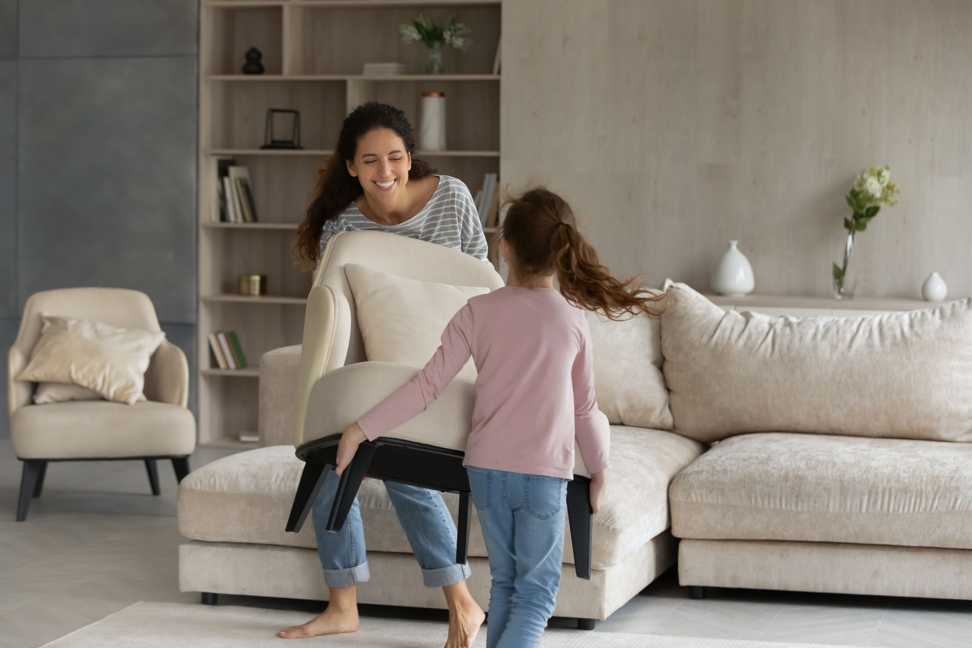 Happy two gen female family homeowners decorating house together.