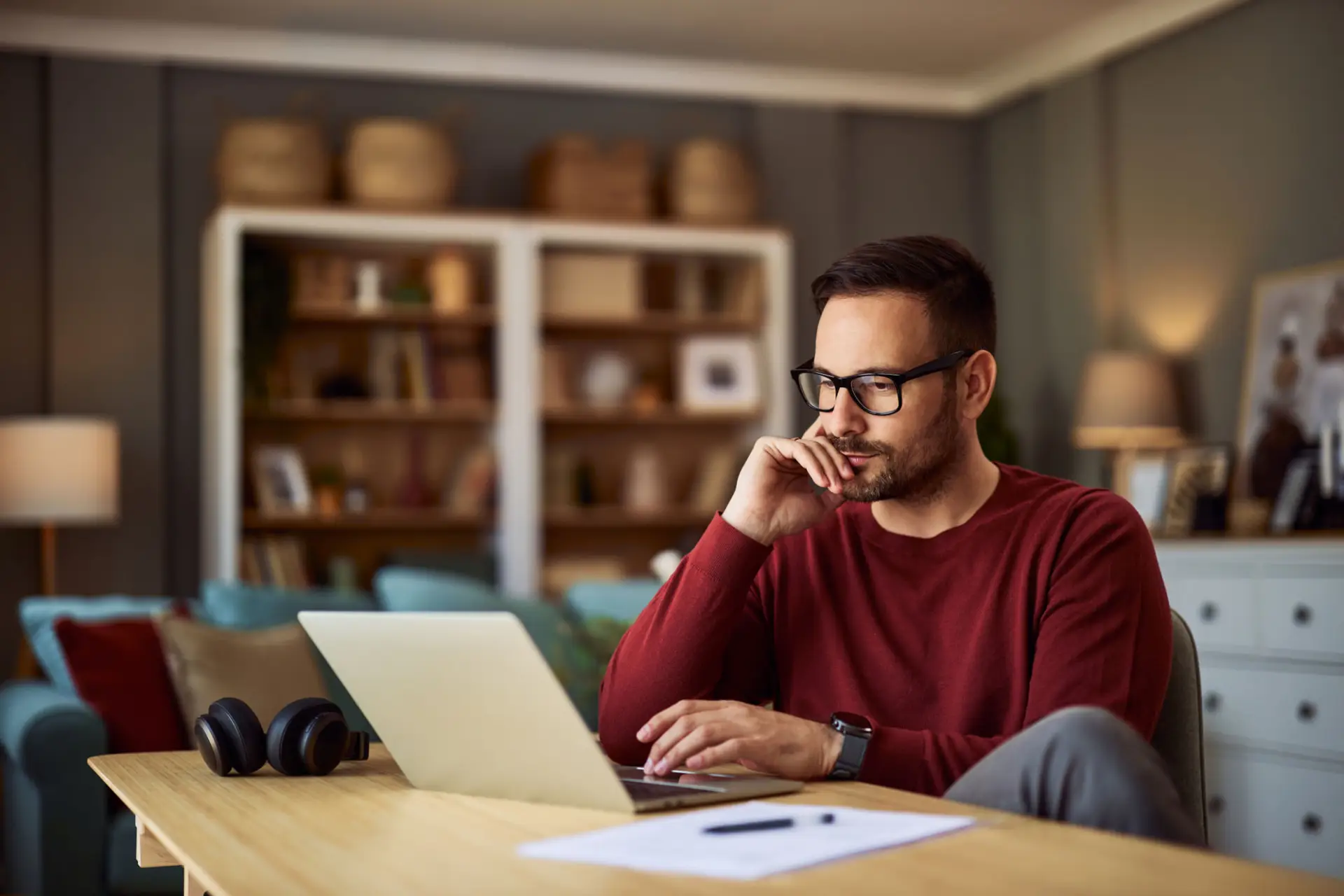 Man sitting at a table reviewing documents for his new self-employed mortgage in Roswell, NM with The Bamman Team.
